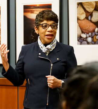 A photo of LaCrisia Gilbert teaching and moving her arms
