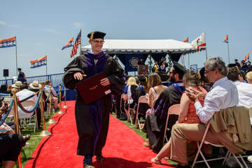 a male student at graduation who earned certificate in dispute resolution