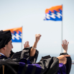 Hands waving in the air at graduation